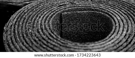 Closeup of Roll of new black roofing felt or bitumen. Shallow depth off field Royalty-Free Stock Photo #1734223643