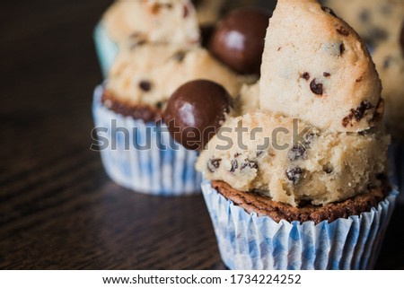 A beautiful picture of yummy chocolate cupcakes on a wooden table - perfect background for pastry shop
