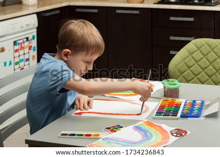 Photo of children's leisure at home. Positive visual support during home quarantine of the Covid-19 pandemic coronavirus. concept of a child's home activities. rainbow.