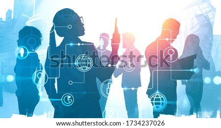 Silhouettes of diverse business people working and communicating in abstract city with double exposure of blurry creative futuristic internet and online business interface. Toned image