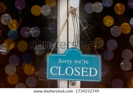 A sign that says "Sorry, we're closed"which  the shop close due to financial difficulties and economic crisis.