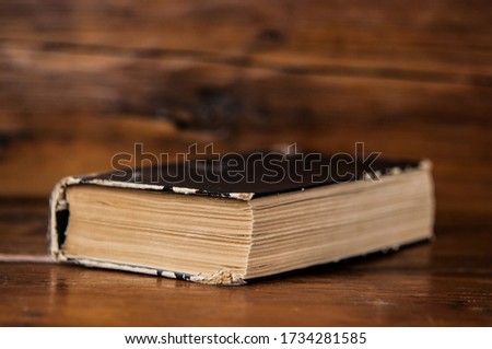 Close up of old book on wooden table