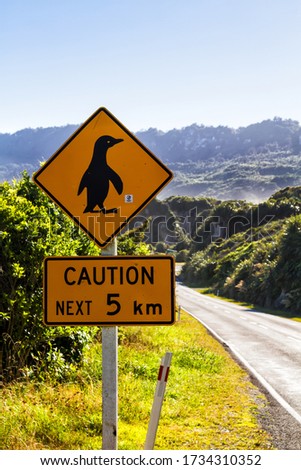 New Zealand Road Sign, Attention Penguin Crossing on side of a road