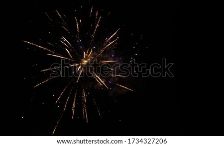 Holiday background with firework. Beautiful Single Golden firework isolated on black background. Template With Copy Space for design Greeting card for holidays and celebrations