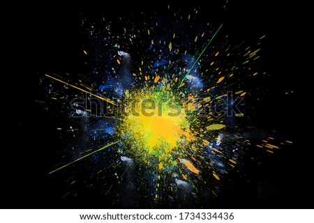 Freeze motion colorful powder paint exploding isolated on black dark background. Abstract design of color dust cloud. Particles explosion screen saver wallpaper, brush. Vivid yellow orange green blue