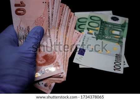 Holding money with medical gloves. Protection from corona-virus with medical gloves. Dirty money due to covid-19.