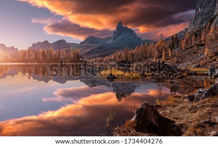 Fantastic colorful scenery in mountains during sunset. Fabulous landscape over calm mountain lake Federa in the summer morning, picture of Wild area. Stunning Natural Background. Creative image 