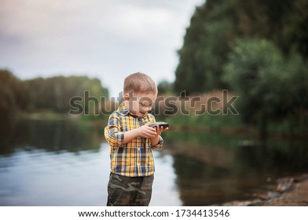 The boy is fishing. Photo taken with selective focus and noise effect.