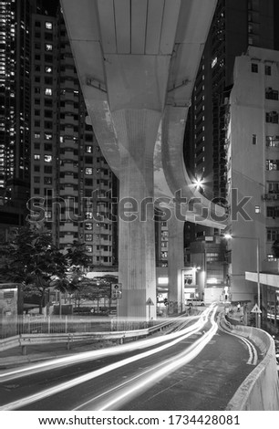 Elevated road through residential building in Hong Kong city at night