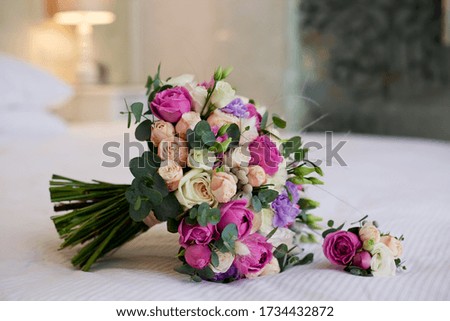 Beautiful wedding bouquet with pink flowers lies in the room
