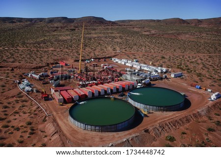 Vaca Muerta, Argentina, August 26, 2014: Extraction of unconventional oil. Battery of pumping trucks for hydraulic fracturing (Fracking). Royalty-Free Stock Photo #1734448742