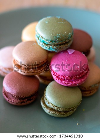 Colorful macarons on black background, close up view