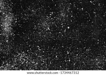 Distressed background. Stained surface layer. White dust scratches on black copy space.