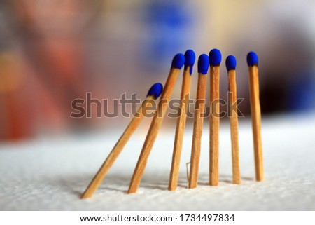 Close up of blue wooden matches on colorful bright metaphor background. Leadership, family, teamwork, life strength and togetherness illustration concept.