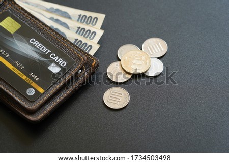 Japan currency paper banknote and coins on dark background, banking economic and finance concept, Japanese money investment ,profit and savings ( credit card is a Photo Props )