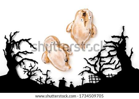 Two baked ghosts above a Cemetery