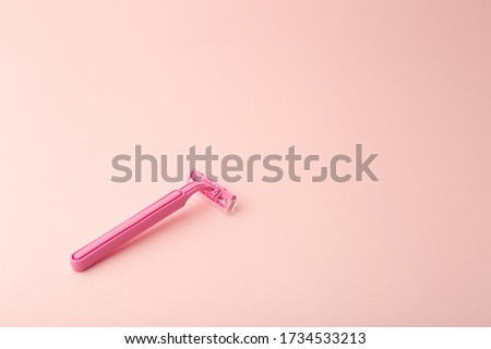 Female shaving razor on a pink background. Skin care, cosmetics, and female beauty concept. Royalty-Free Stock Photo #1734533213