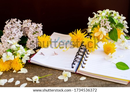 Apple tree dandelion lilac flowers and notebook