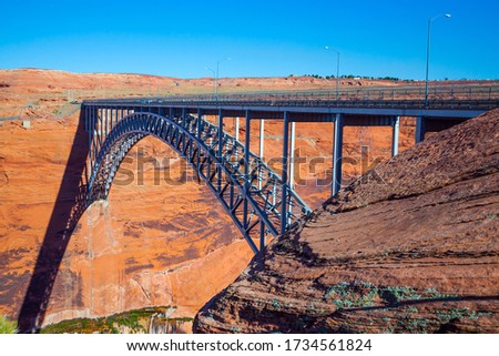 Glen Canyon Bridge over the Colorado River next to the Glen Canyon Dam. Arched bridge from one giant steel arch.  The largest man-made reservoir in the United States is Lake Powell