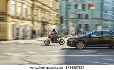 Fast motorcycle riding on a city street.