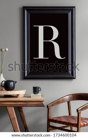 Stylish and minimalistic dining room interior with wooden table, chair, tea pot with cups, flowers, black mock up poster frame and elegant accessories in modern home decor. 