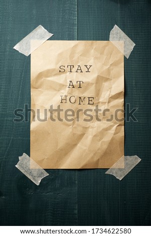 Stay at Home text on a wall.