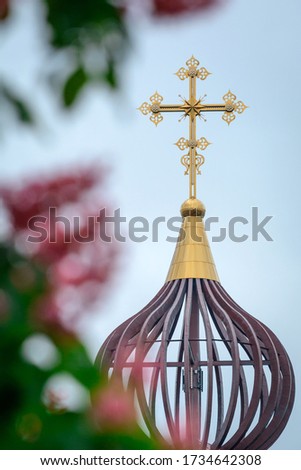 Orthodox cathedral dome and blooming chestnut trees