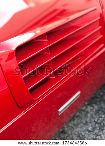 close-up of air intake of italian supercar. Bodywork of red color.