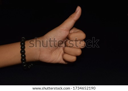 Hands in Merudanda mudra isolated on black background. Merudanda mudra is a simple yoga hand gesture used in meditation or pranayama that helps the yogi focus on the breath.