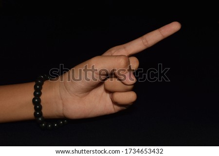 Hands in Suchi mudra isolated on black background.