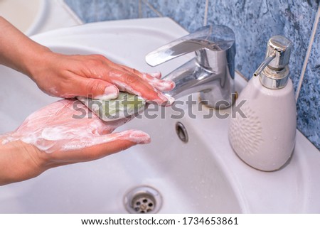 woman clearly washes her hands with soap in the bathroom close up. warning against viruses. koronavirus. Royalty-Free Stock Photo #1734653861