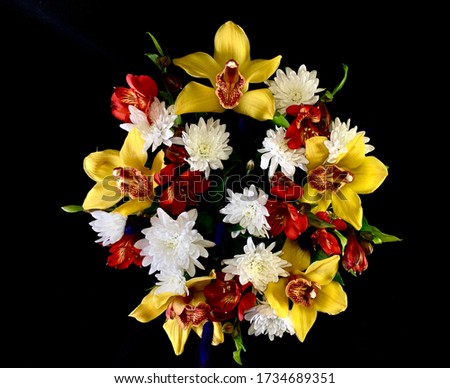 Beautiful wedding bouquet of flowers. Multi-colored flowers on a black background. Spring bouquet, a combination of yellow, white and red.