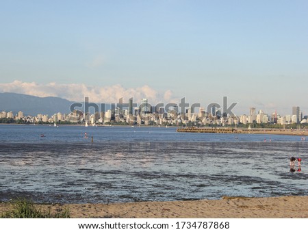 children play on a beach at low tide in Vancouver BC Canada