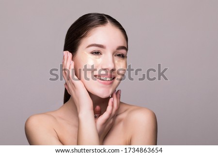 woman with an eye patches touching temples. skin stress concept