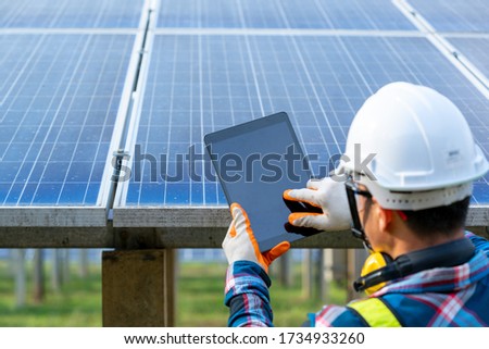 Engineer checking solar panel in routine operation at solar power plant,Solar power plant to innovation of green energy for life adjustment. 
