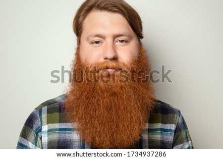 A man with a beautiful red hair and a red beard on a white background. Bearded man.