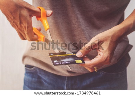 Man cutting credit card with scissors. Royalty-Free Stock Photo #1734978461