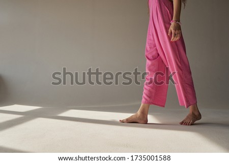 Beautiful legs in pink panties. sun shining through the window in white room. funny home clothes