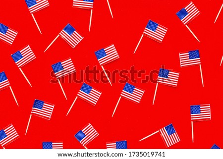 July 4th. USA flags on red background. Independence Day Of America. Flat lay, top view, template