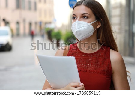 COVID-19 Global Economic Crisis Unemployed Worried Girl with KN95 FFP2 Mask  Looking for Job Walking in City Street Delivering Curriculum Vitae
