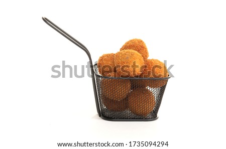 Dutch traditional snack bitterbal in a small basket, isolated Royalty-Free Stock Photo #1735094294