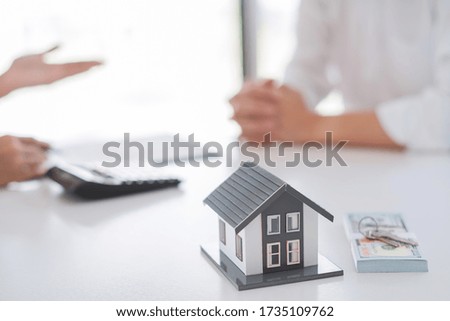 Real estate agents explain the document for customers who come to contact to buy a house, buy or sell real estate concept