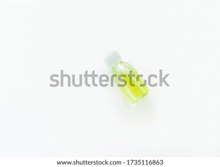 White transparent bottle with yellow-green liquid for cosmetic or hygiene procedures