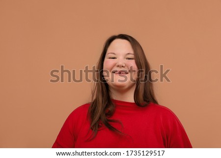 Beautiful young girl in a bright red jacket, overweight girl.
