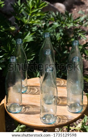 Set of empty bottles on green backgroud