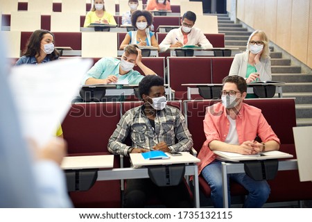 education, pandemic and health concept - group of international students wearing face protective medical mask for protection from virus disease at lecture hall