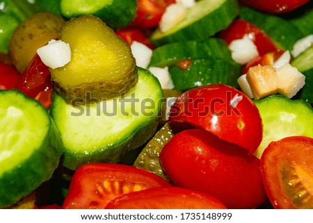 Vegetable salad sliced tomatoes, cucumbers, onions and pickles. Close up. Healthy food, fitness diet.
