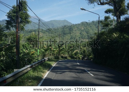 road with a mountain and crossing