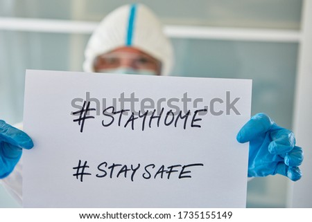 #stayhome #staysafe Message held by a clinic staff at coronavirus and Covid-19 pandemic Royalty-Free Stock Photo #1735155149