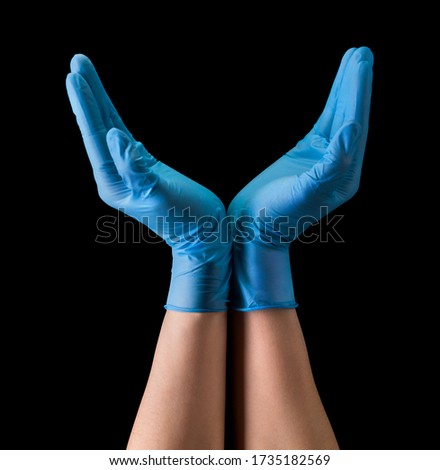 Doctor's hand in sterile medical gloves hold earth shape isolated on black background with clipping path. Concept of protection against pandemic and viruses.